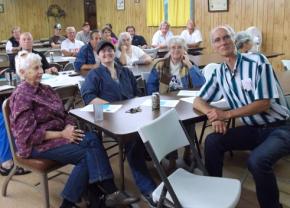 Oregon's "Postal Road Warrior" Jamie Partridge (front right) at a meeting in Lorane