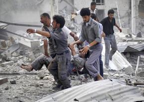 Residents of Douma carry a wounded man after the regime's air strikes hit a crowded market